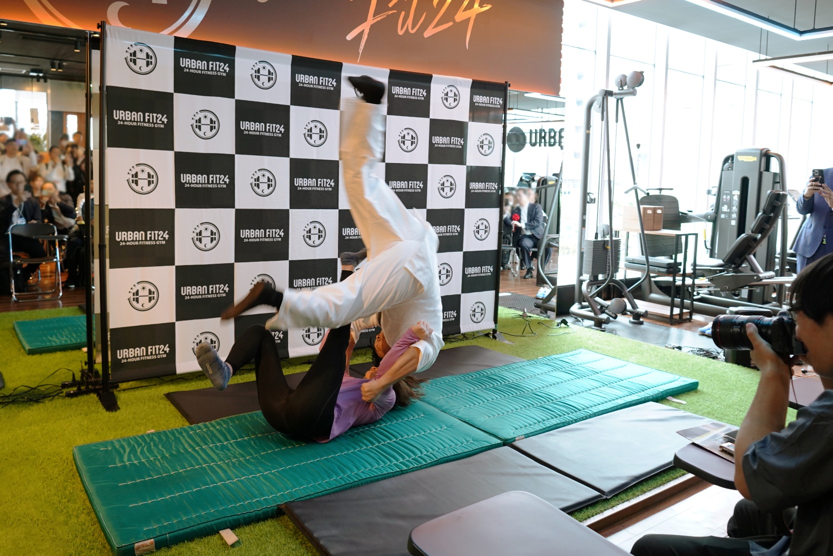 角田選手の巴投げをアーバンフィットの広報 﨑山が体験。100kg超で柔道初段でもある﨑山を軽々と投げていました。